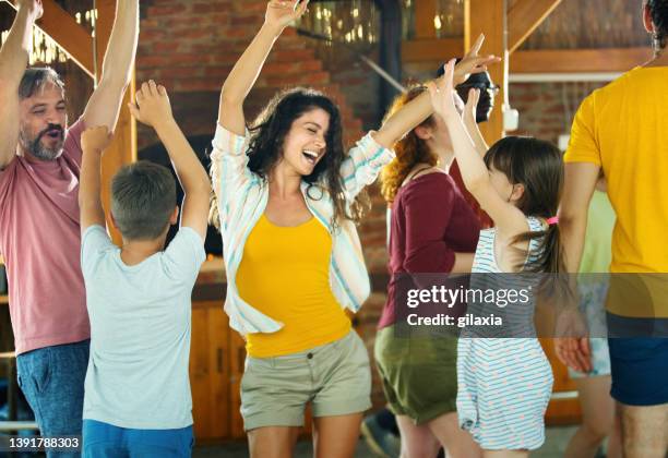 family dancing at a weekend house party. - children dancing outside stockfoto's en -beelden