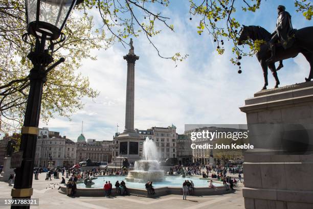 General view of people visiting Trafalgar Square and Nelson's column on a warm sunny day April 14, 2022 in London, England.
