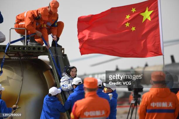 Astronaut Wang Yaping waves as she is helped to disembark from the return capsule at the Dongfeng landing site on April 16, 2022 in Ejin Banner, Alxa...