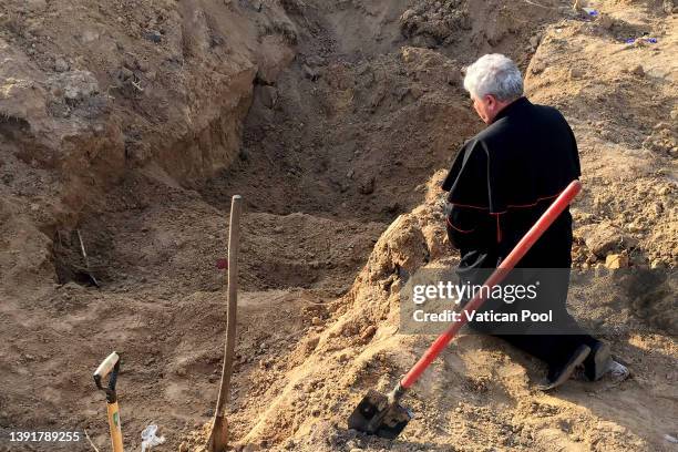 Cardinal Konrad Krajewski, the Papal Almoner, prays at the site of a mass grave in nearby Borodyanka during Good Friday on April 15, 2022 in Kyiv,...