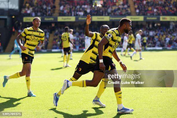 Emmanuel Dennis of Watford FC celebrates with teammates after scoring their team's first goal during the Premier League match between Watford and...
