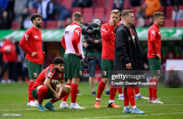 Players of Augsburg look dejected after the final whistle of the Bundesliga match between FC Augsburg and Hertha BSC at WWK-Arena on April 16, 2022...