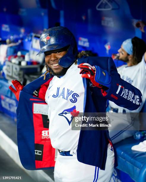 Vladimir Guerrero Jr. #27 of the Toronto Blue Jays celebrates with the home run jacket in the dugout while playing against the Oakland Athletics in...