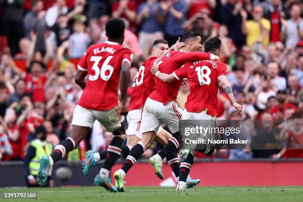 Cristiano Ronaldo of Manchester United celebrates with team mate Bruno Fernandes after scoring their sides third goal and hat-trick during the...