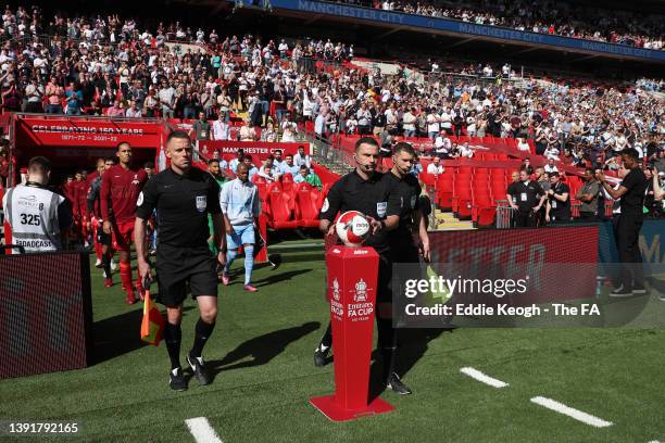 Referee, Michael Oliver collects the match ball from the plinth as both teams take to the field during The Emirates FA Cup Semi-Final match between...