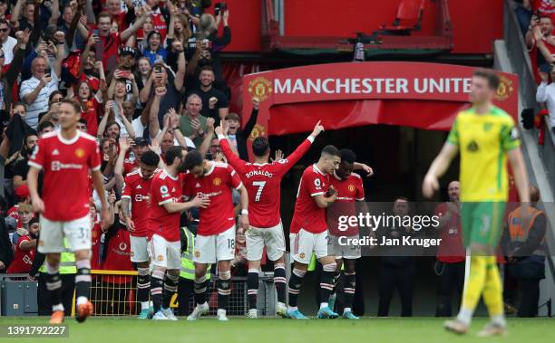 Cristiano Ronaldo of Manchester United celebrates with team mates after scoring their sides third goal and hat-trick during the Premier League match...