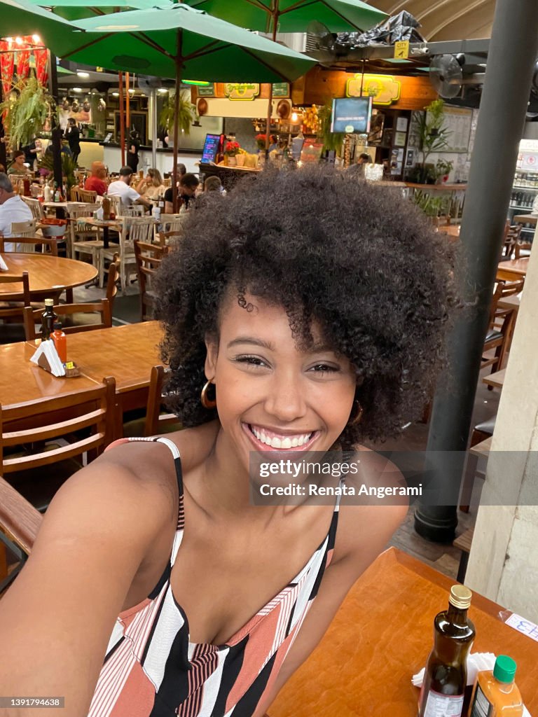 Portrait of beautiful woman making selfie in the municipal market
