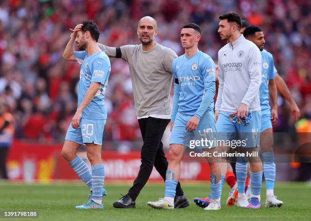 Pep Guardiola, Manager of Manchester City consoles Bernardo Silva and Phil Foden of Manchester City following defeat in The Emirates FA Cup...