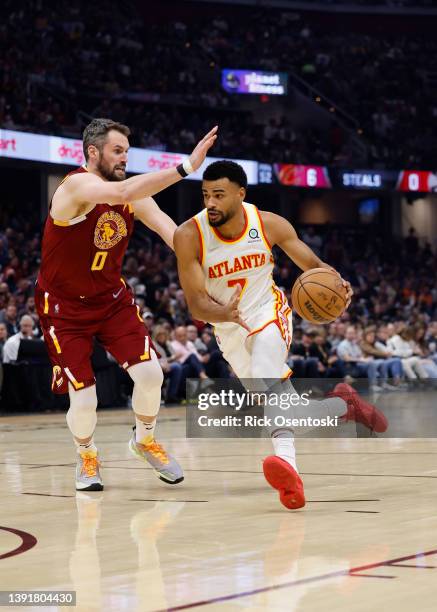 Timothe Luwawu-Cabarrot of the Atlanta Hawks dribbles defended by Kevin Love of the Cleveland Cavaliers at Rocket Mortgage Fieldhouse on April 15,...