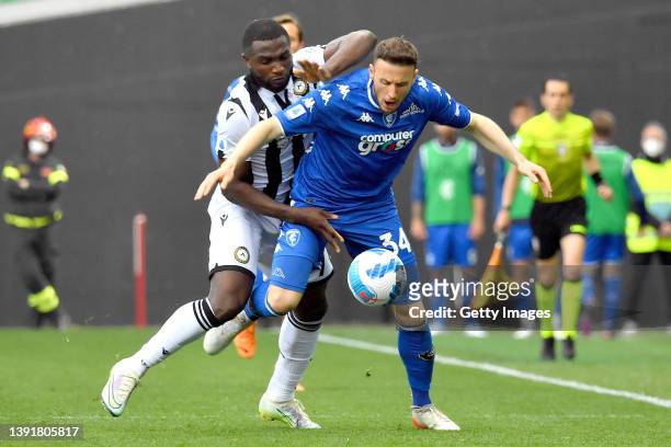 Isaac Success of Udinese Calcio competes for the ball with Ardian Ismajli of Empoli FC during the Serie A match between Udinese Calcio and Empoli FC...