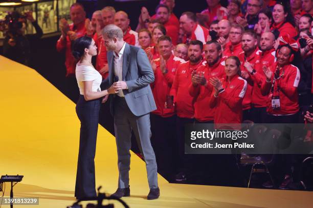 Meghan, Duchess of Sussex and Prince Harry, Duke of Sussex appear on stage during the Invictus Games The Hague 2020 Opening Ceremony at Zuiderpark on...