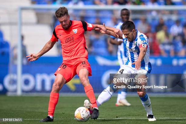 Recio of CD Leganes battle for the ball with Genaro Rodriguez of Malaga CF during the LaLiga Smartbank match between CD Leganes and Malaga CF at...