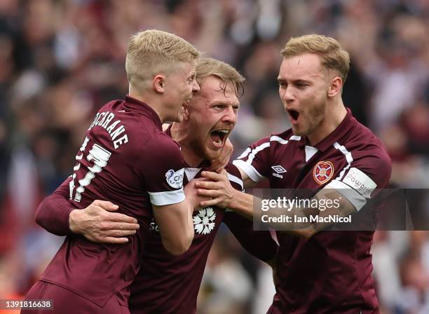Stephen Kingsley of Heart of Midlothian celebrates with teammates Alex Cochrane and Nathaniel Atkinson after scoring their team's second goal during...