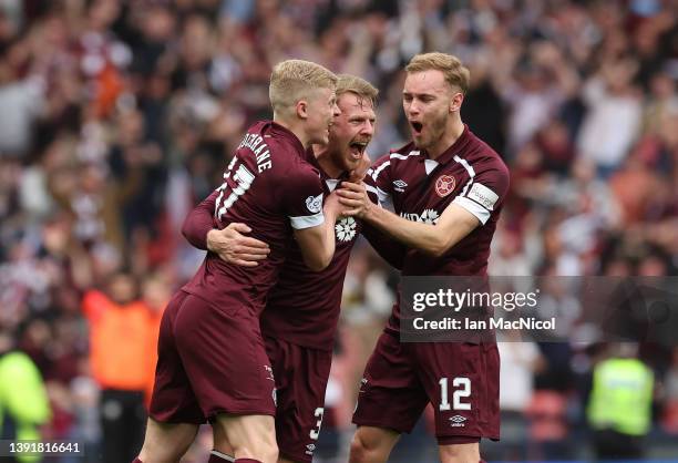 Stephen Kingsley of Heart of Midlothian celebrates with teammates Alex Cochrane and Nathaniel Atkinson after scoring their team's second goal during...