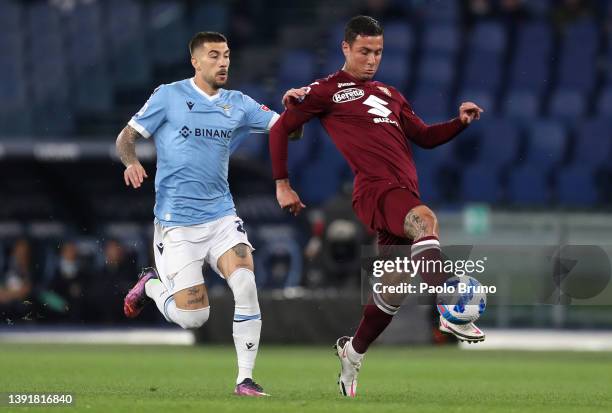 Luis Alberto of Lazio marks Armando Izzo of Torino during the Serie A match between SS Lazio and Torino FC at Stadio Olimpico on April 16, 2022 in...