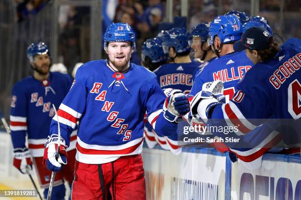 Alexis Lafrenière of the New York Rangers high-fives the bench after scoring a goal during the third period against the Detroit Red Wings at Madison...