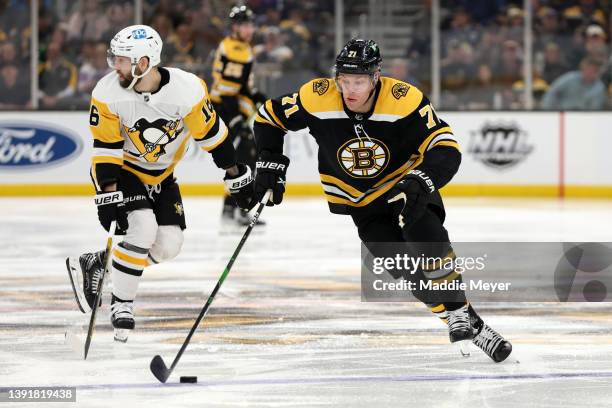 Taylor Hall of the Boston Bruins skates past Jason Zucker of the Pittsburgh Penguins during the third period at TD Garden on April 16, 2022 in...