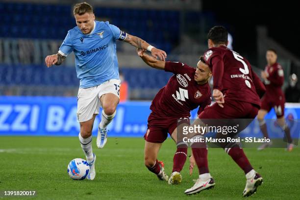 Ciro Immobile of SS Lazio compete for ythe ball with Samuele Ricci of Torino FC during the Serie A match between SS Lazio and Torino FC at Stadio...