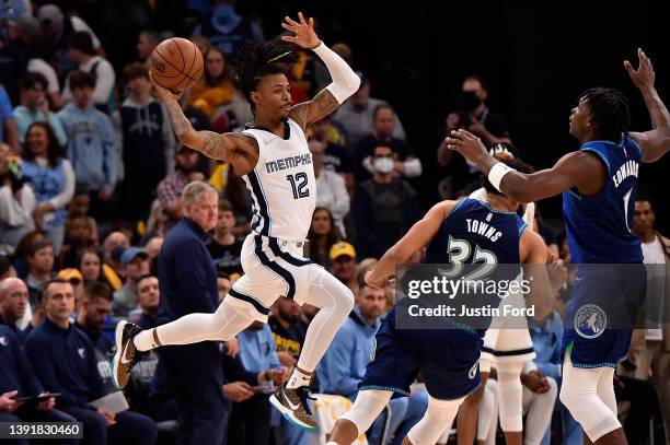 Ja Morant of the Memphis Grizzlies look sto pass against Anthony Edwards of the Minnesota Timberwolves during the first half of Game One of the...