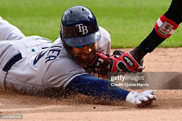 Kevin Kiermaier of the Tampa Bay Rays is tagged out trying to advance to third base in the ninth inning against Josh Harrison of the Chicago White...