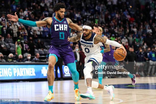 Angelo Russell of the Minnesota Timberwolves drives to the basket while Miles Bridges of the Charlotte Hornets defends during overtime at Target...