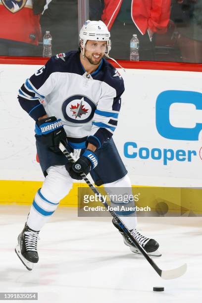 Brenden Dillon of the Winnipeg Jets skates with the puck prior to the game against the Florida Panthers at the FLA Live Arena on April 15, 2022 in...