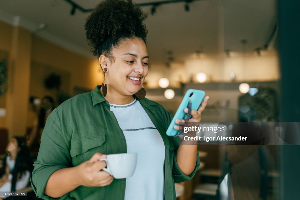 Woman using smartphone at coffee shop