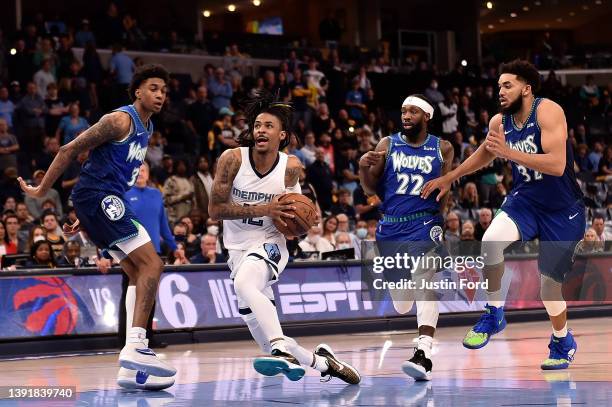 Ja Morant of the Memphis Grizzlies goes to the basket against Jaden McDaniels of the Minnesota Timberwolves during the second half of Game One of the...