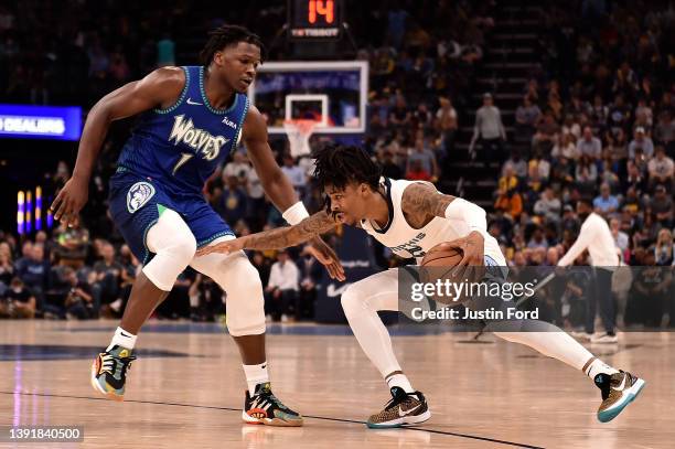 Ja Morant of the Memphis Grizzlies handles the ball against Anthony Edwards of the Minnesota Timberwolves during the second half of Game One of the...