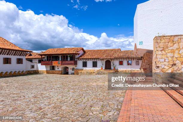 in the principal town square of the andes town of guatavita, in colombia, south america, looking at the northern side of the square. spanish colonial style architecture. - cundinamarca stock pictures, royalty-free photos & images