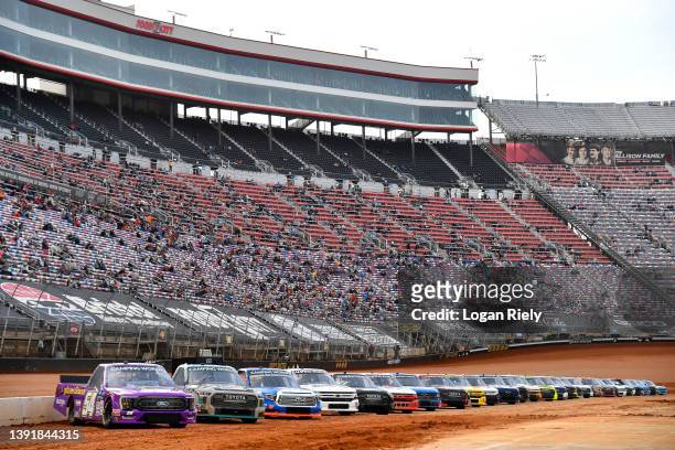 General view of trucks parked on the grid during qualifying for the NASCAR Camping World Truck Series Pinty's Truck Race on Dirt at Bristol Motor...