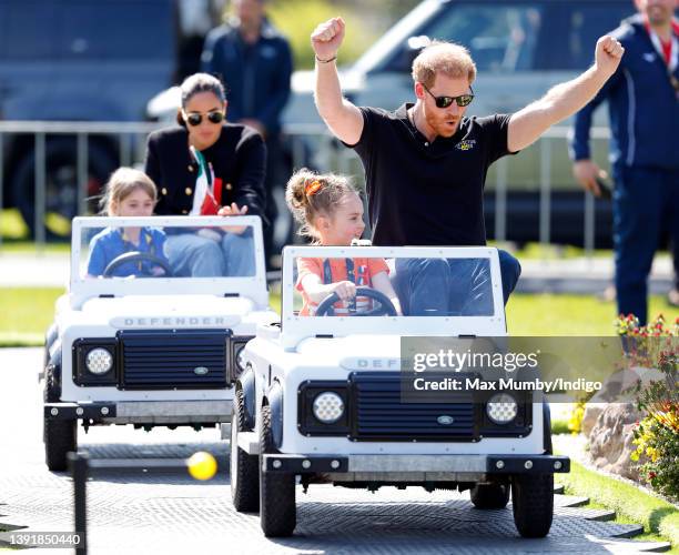 Meghan, Duchess of Sussex and Prince Harry, Duke of Sussex accompany young children driving mini Land Rover Defenders at the Land Rover Driving...
