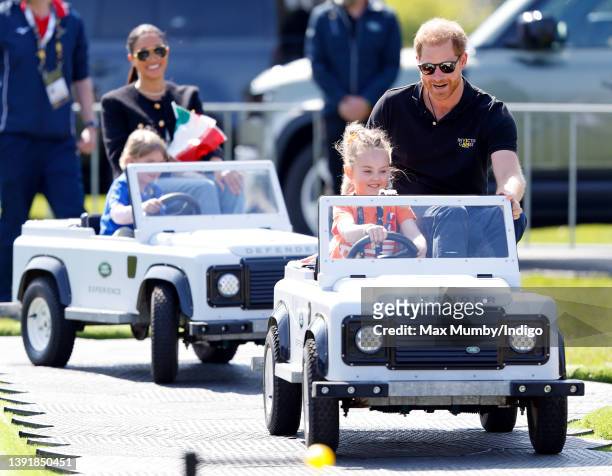 Meghan, Duchess of Sussex and Prince Harry, Duke of Sussex accompany young children driving mini Land Rover Defenders at the Land Rover Driving...