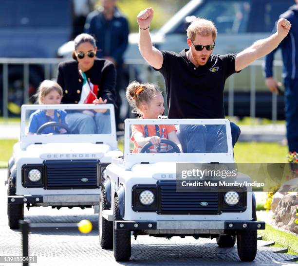 Meghan, Duchess of Sussex and Prince Harry, Duke of Sussex accompany young children driving mini Land Rover Defenders at the Land Rover Driving...