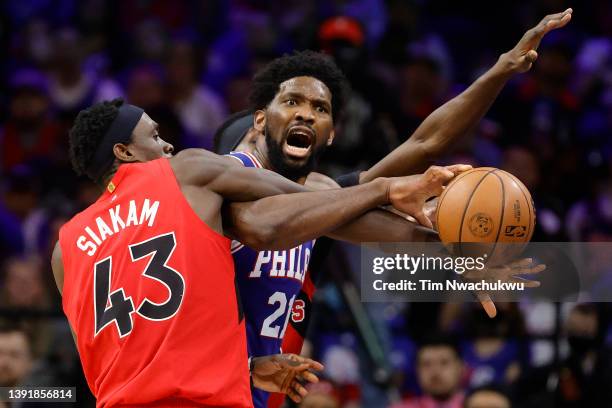 Joel Embiid of the Philadelphia 76ers is guarded by Pascal Siakam of the Toronto Raptors during the fourth quarter during Game One of the Eastern...