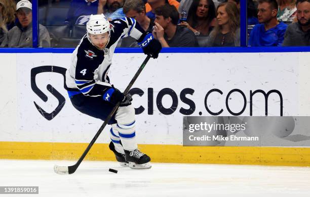 Neal Pionk of the Winnipeg Jets looks to pass in the third period during a game against the Tampa Bay Lightning at Amalie Arena on April 16, 2022 in...