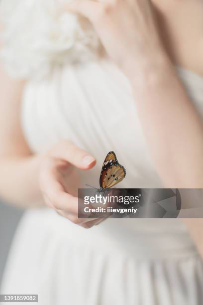 girl with orange butterfly on hand. beauty. greek goddess. purity and innocence - animal body part stock pictures, royalty-free photos & images