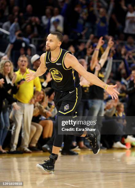 Stephen Curry of the Golden State Warriors reacts after he made a three-point basket against the Denver Nuggets at the end of the first half during...