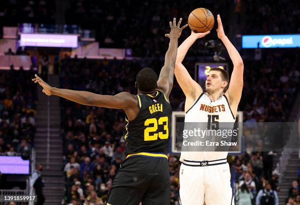 Nikola Jokic of the Denver Nuggets shoots over Draymond Green of the Golden State Warriors in the first half during Game One of the Western...