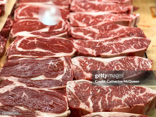 boneless ribeye & boneless new york strip steaks at market - kött utan ben bildbanksfoton och bilder