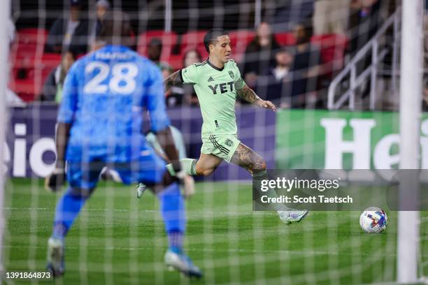 Sebastián Driussi of Austin FC kicks the ball as Bill Hamid of D.C. United tends goal during the second half of the MLS game at Audi Field on April...