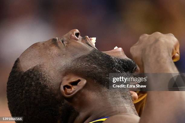 Draymond Green of the Golden State Warriors reacts after making a basket and being fouled by the Denver Nuggets in the second half during Game One of...