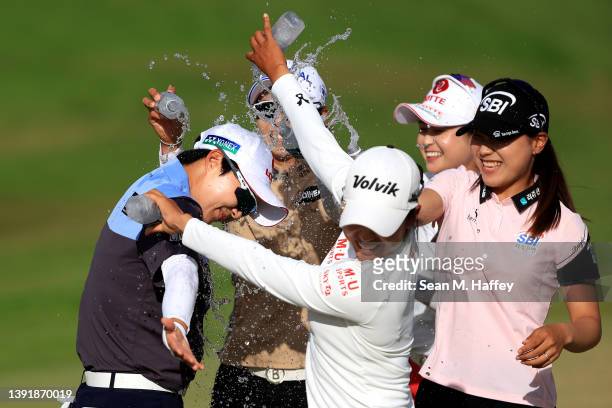 Tour players Mi Hyang Lee, Somi Lee, Na Rin An, and Hye-Jin Choi spray water on Hyo Joo Kim of The Republic of Korea after she won the LOTTE...