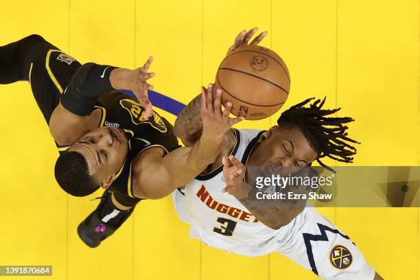 Otto Porter Jr. #32 of the Golden State Warriors and Bones Hyland of the Denver Nuggets go for a rebound during Game One of the Western Conference...