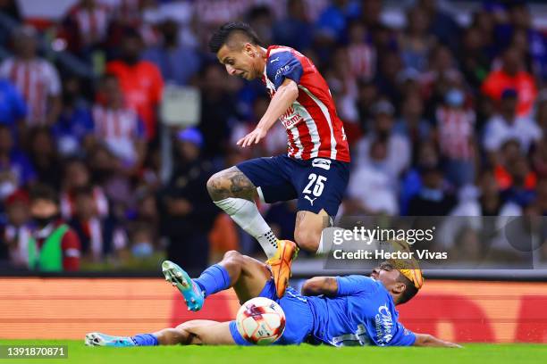 Roberto Alvarado of Chivas fights for the ball with Adrian Aldrete of Cruz Azul during the 14th round match between Cruz Azul and Chivas as part of...