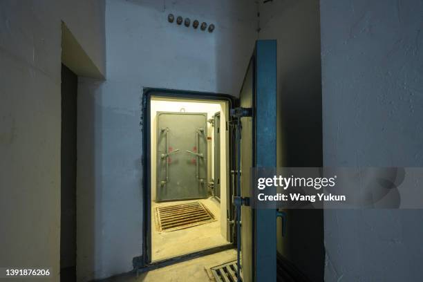 strong iron gate in basement - military bunker stock pictures, royalty-free photos & images