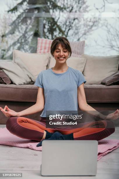 meditating after a yoga class - lotus position imagens e fotografias de stock