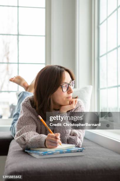 teenager girl student writing looking out window - nicho imagens e fotografias de stock