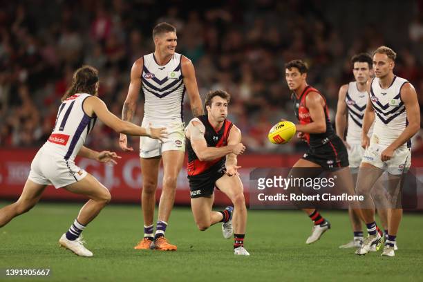 Andrew McGrath of the Bombers handballs during the round five AFL match between the Essendon Bombers and the Fremantle Dockers at Marvel Stadium on...