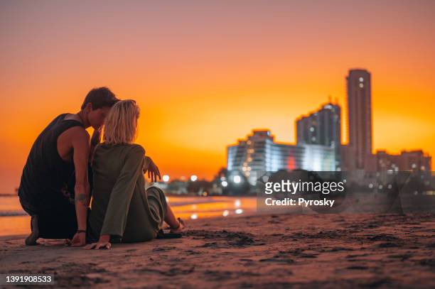enjoying in sunset with a modern skyscrapers in a background - colombia beach stock pictures, royalty-free photos & images
